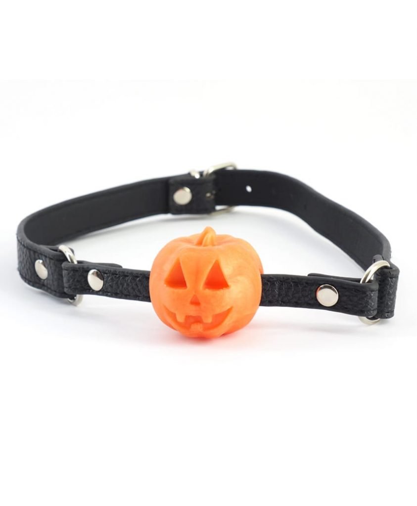 Orange jack-o-lantern Halloween Pumpkin Ball Gag with carved face, black strap and silver hardware