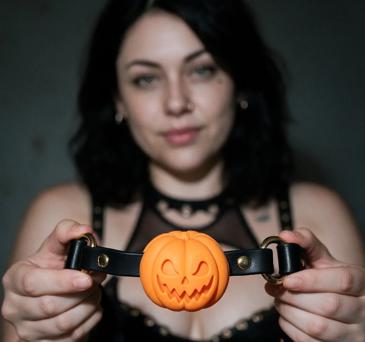 Mara holding the orange Pumpkin Gag towards the camera