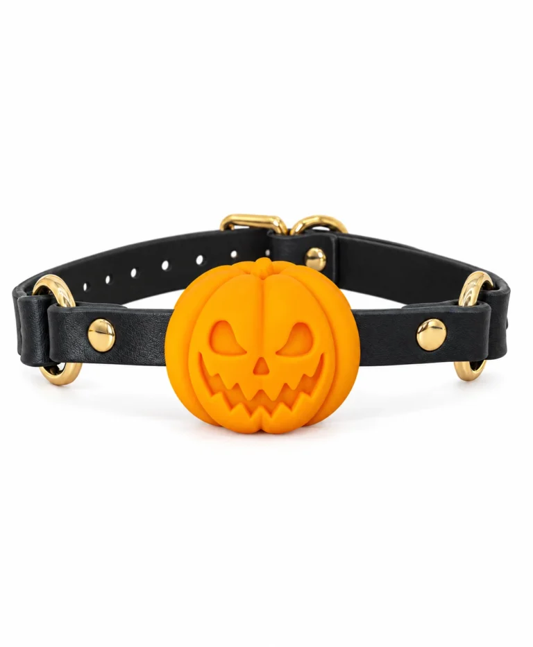 Front close-up of the orange Pumpkin Gag, black faux leather straps and yellow-gold hardware on pure white
