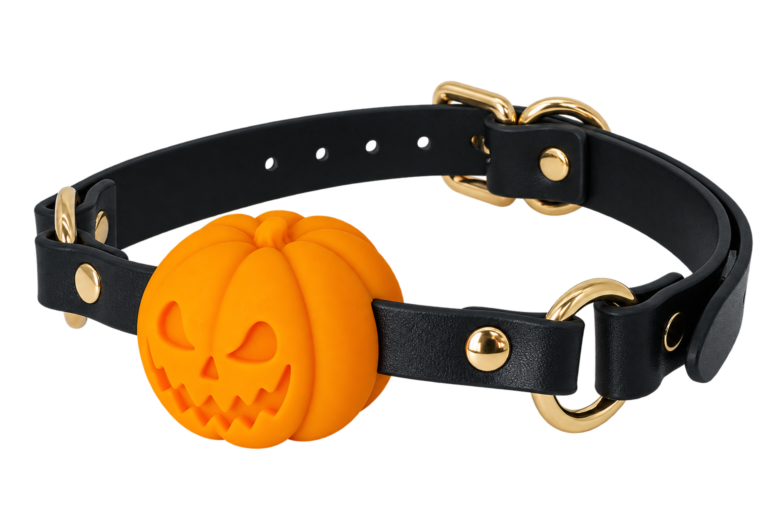 Three-quarter view of the orange Pumpkin Gag with black straps and gold hardware.